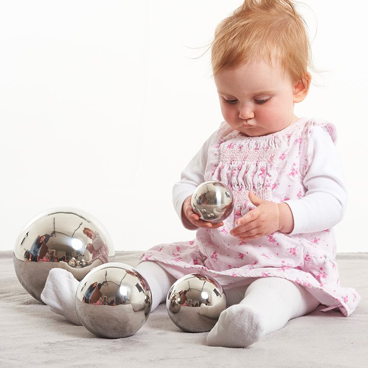 Baby play with silver sensory balls