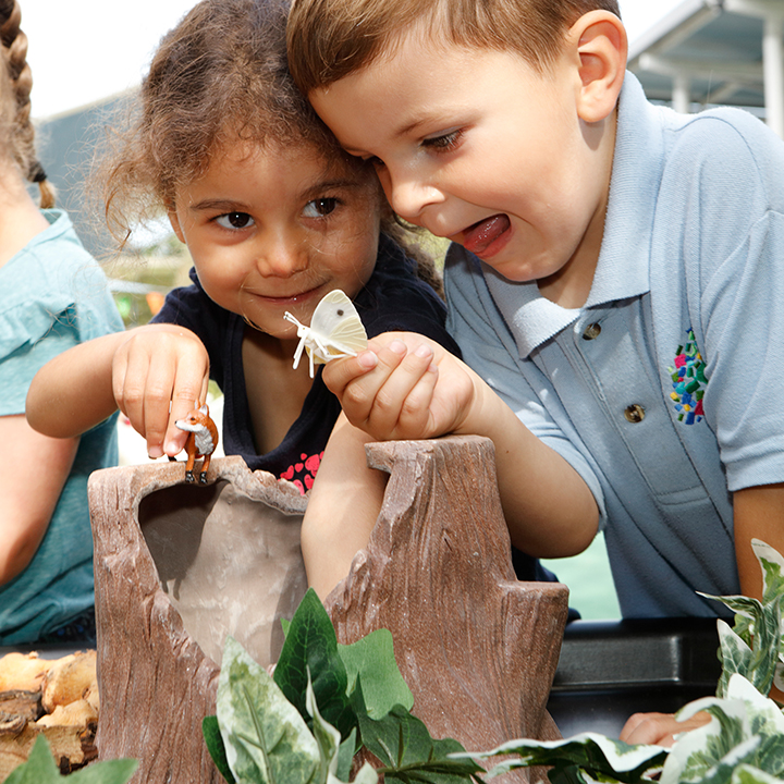 Children playing with tree stump scene