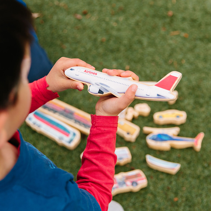 Boy holding wooden plane