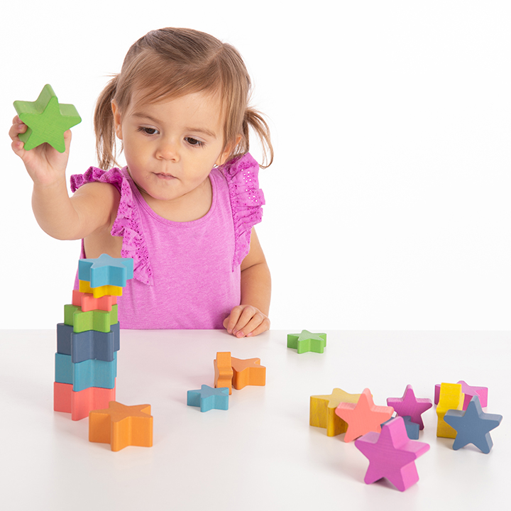 Building a tower of Rainbow Wooden Stars