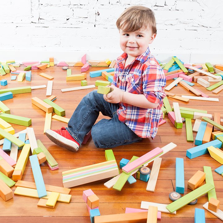 Child with magnetic wooden blocks