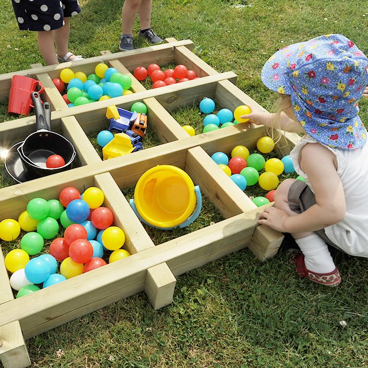 Giant sorting tray with separated objects balls, pans, pots and buckets