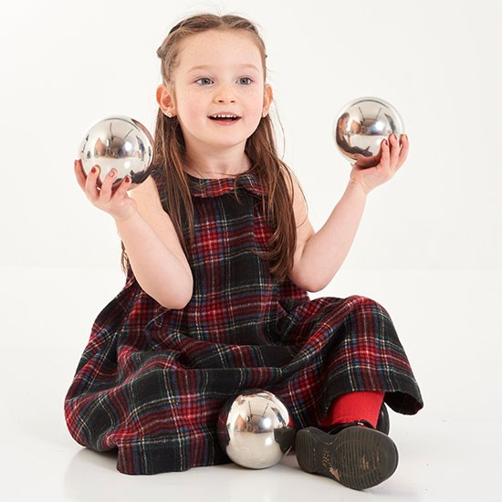 Little girl holding two sensory balls