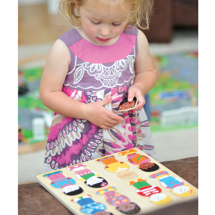Little girl piecing together puzzle
