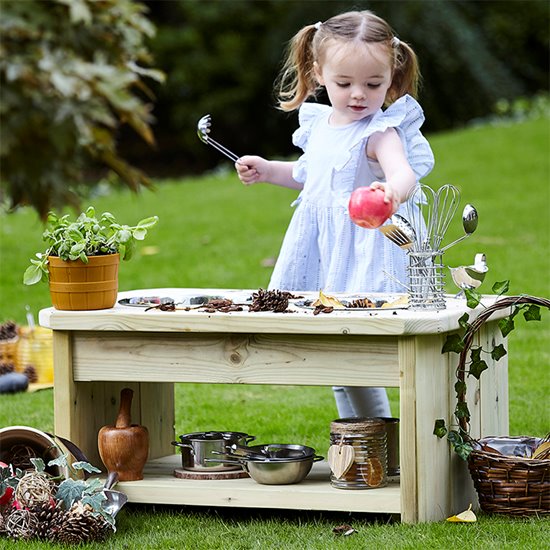 Child in garden with play kitchen