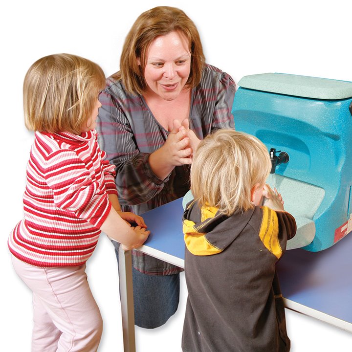 Adult showing children how to use mobile hand wash